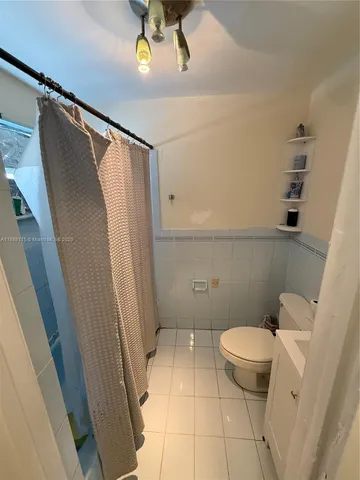 a kitchen with kitchen island a white cabinets and white appliances