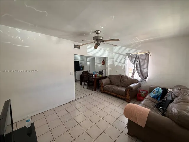 a bed room with a bed and a ceiling fan