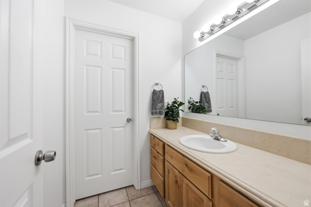 1816 River Bottom Road Springville, UT 84663 - Photo 23 of 37 Bathroom featuring a wood-finish vanity with an integrated sink, a light-toned countertop, a large wall-mounted mirror, and a five-bulb vanity light fixture
