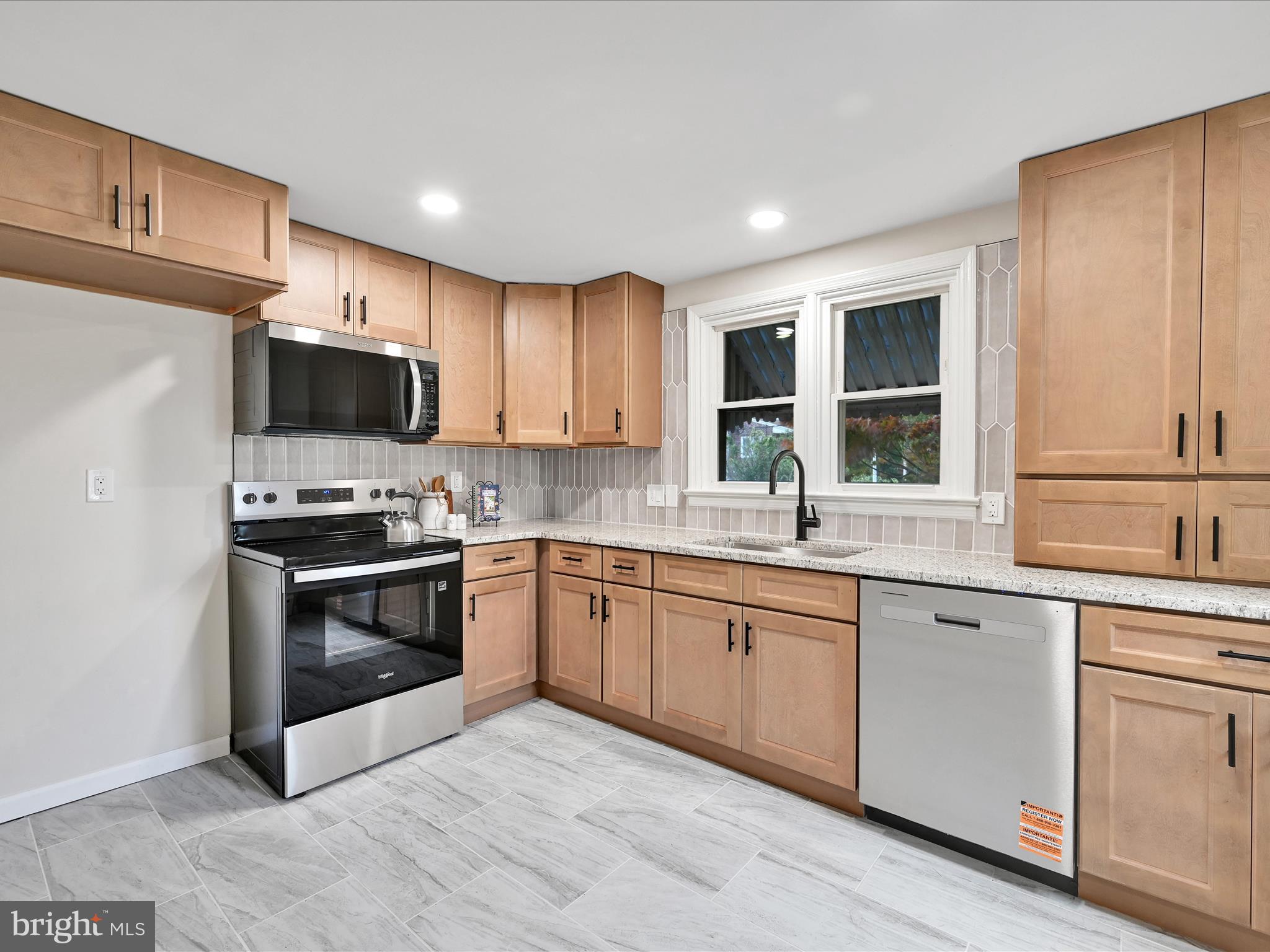 1609 Fayette Avenue Reading, PA 19607 - Photo 12 of 27 a kitchen with granite countertop a stove top oven sink and cabinets