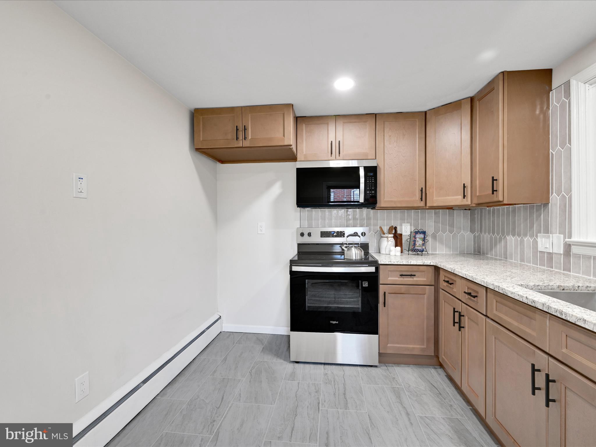 1609 Fayette Avenue Reading, PA 19607 - Photo 13 of 27 a kitchen with stainless steel appliances a stove top oven a sink and cabinets