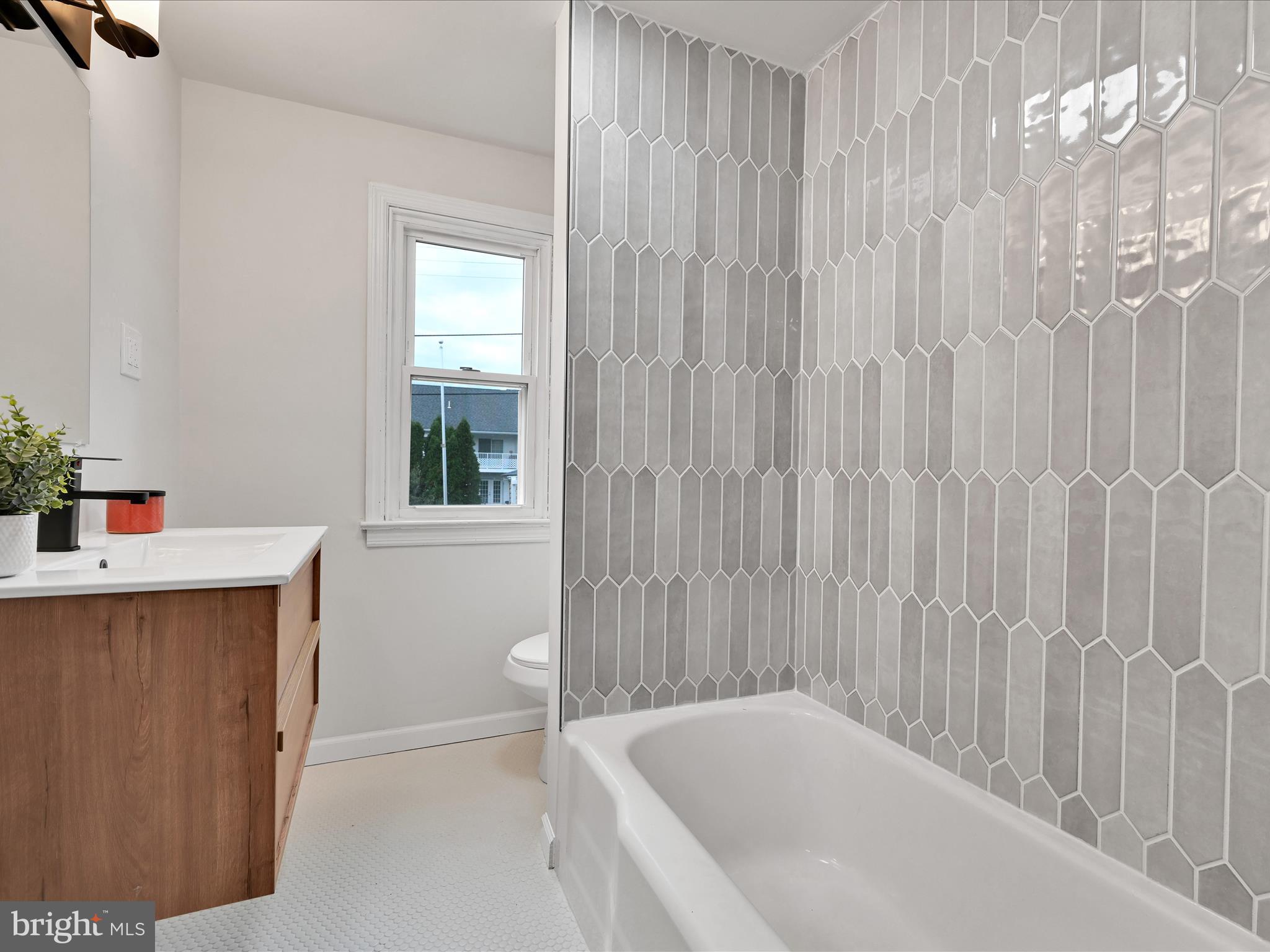 1609 Fayette Avenue Reading, PA 19607 - Photo 20 of 27 a bathroom with a bathtub a sink and a window