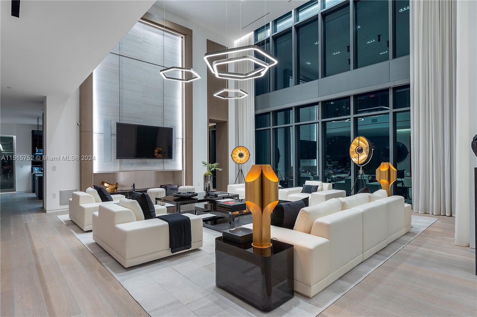 1451 Brickell Avenue, Unit PH56 Miami, FL 33131 - Photo 13 of 54 a living room with furniture a flat screen tv and a fireplace