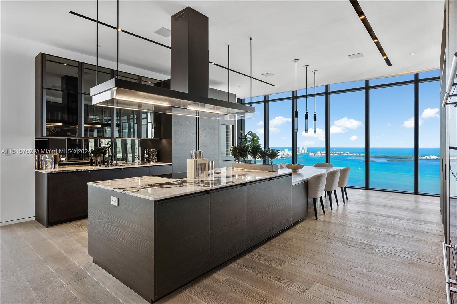 1451 Brickell Avenue, Unit PH56 Miami, FL 33131 - Photo 15 of 54 a kitchen with stainless steel appliances granite countertop a sink and a stove