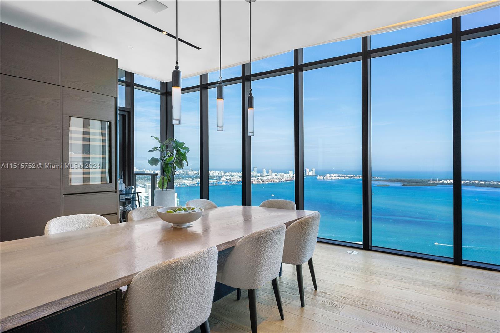 1451 Brickell Avenue, Unit PH56 Miami, FL 33131 - Photo 16 of 54 a dining table with chairs and window