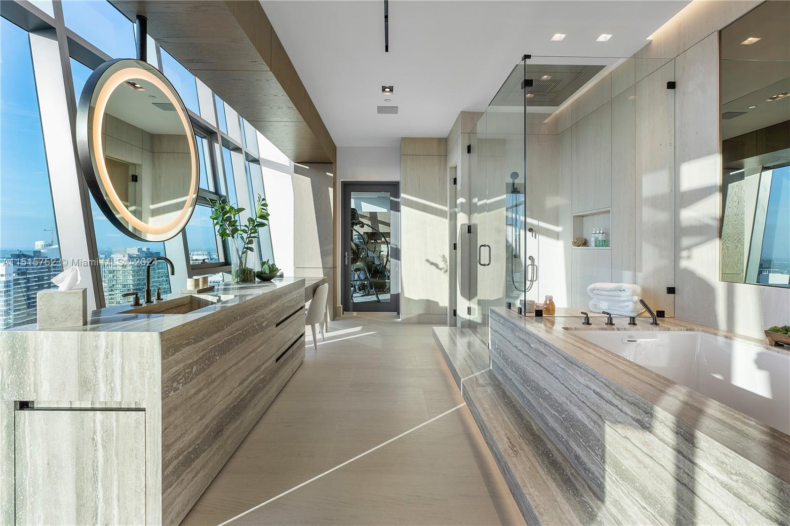 1451 Brickell Avenue, Unit PH56 Miami, FL 33131 - Photo 28 of 54 a large spacious bathroom with a granite countertop double vanity mirror and a bathtub