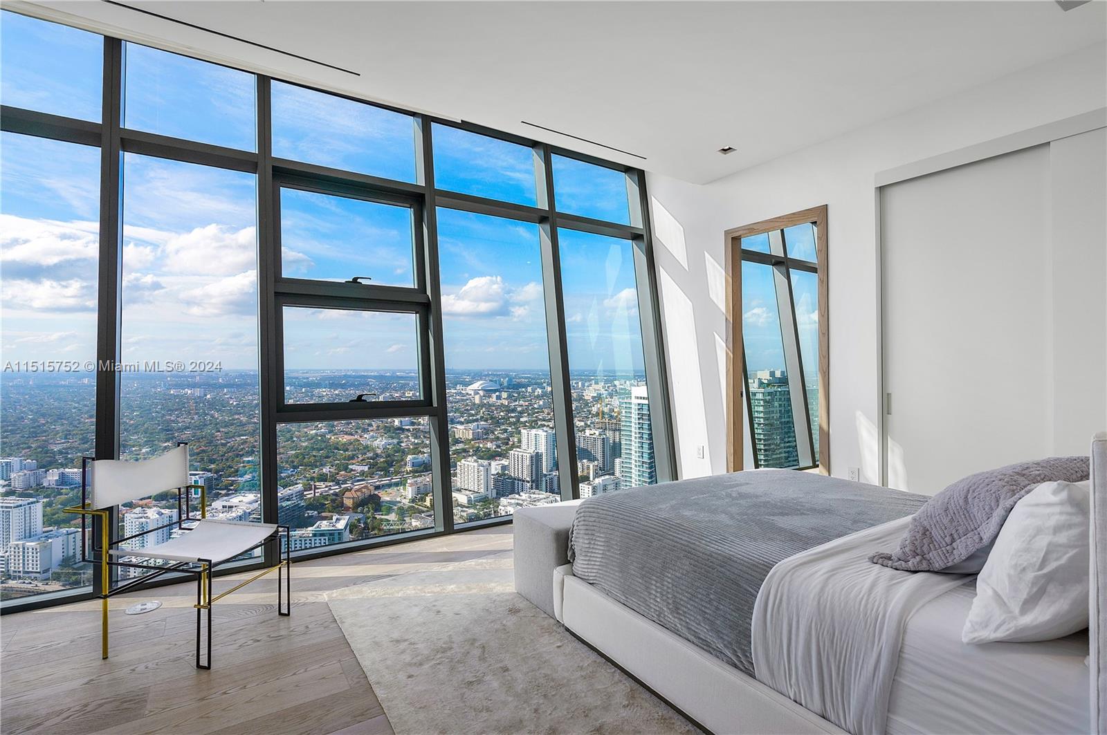 1451 Brickell Avenue, Unit PH56 Miami, FL 33131 - Photo 32 of 54 a bedroom with a large window and a bed