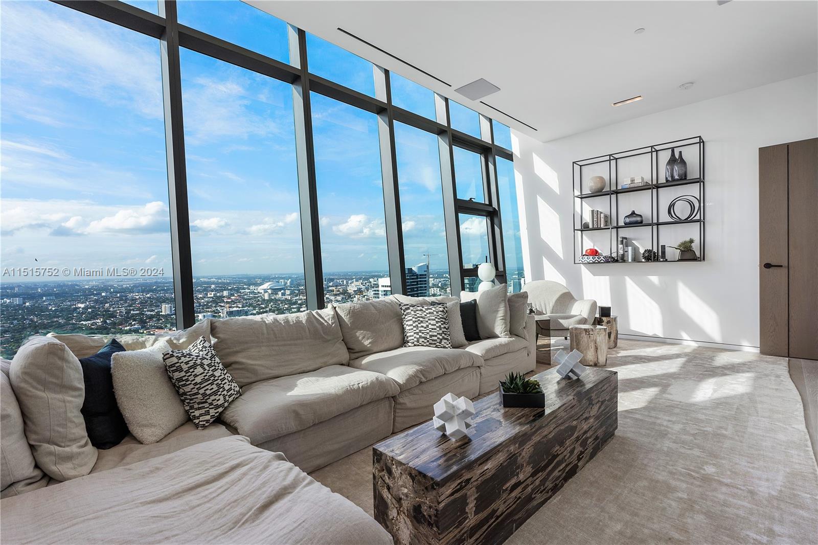 1451 Brickell Avenue, Unit PH56 Miami, FL 33131 - Photo 34 of 54 a living room with furniture and a large window