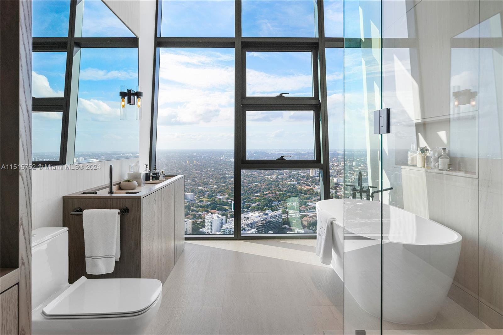 1451 Brickell Avenue, Unit PH56 Miami, FL 33131 - Photo 36 of 54 a living room with furniture a large window and a wooden floor