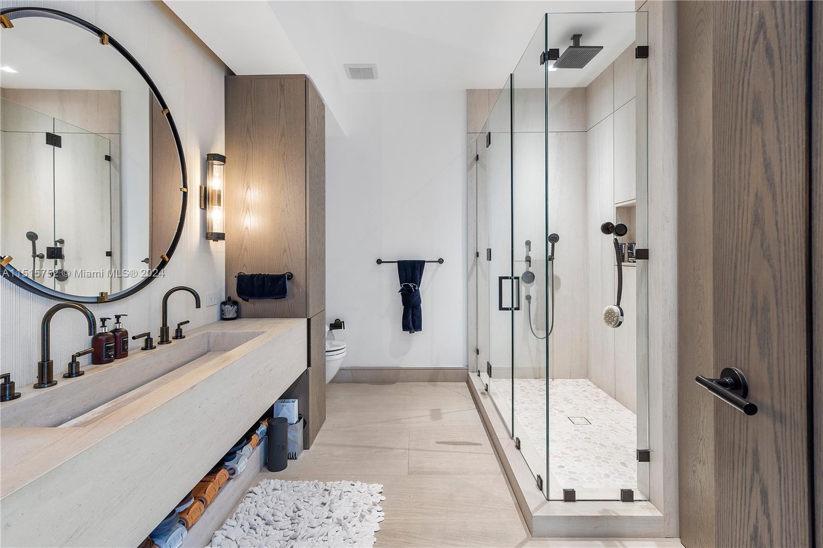 1451 Brickell Avenue, Unit PH56 Miami, FL 33131 - Photo 38 of 54 a bathroom with a double vanity sink mirror and shower