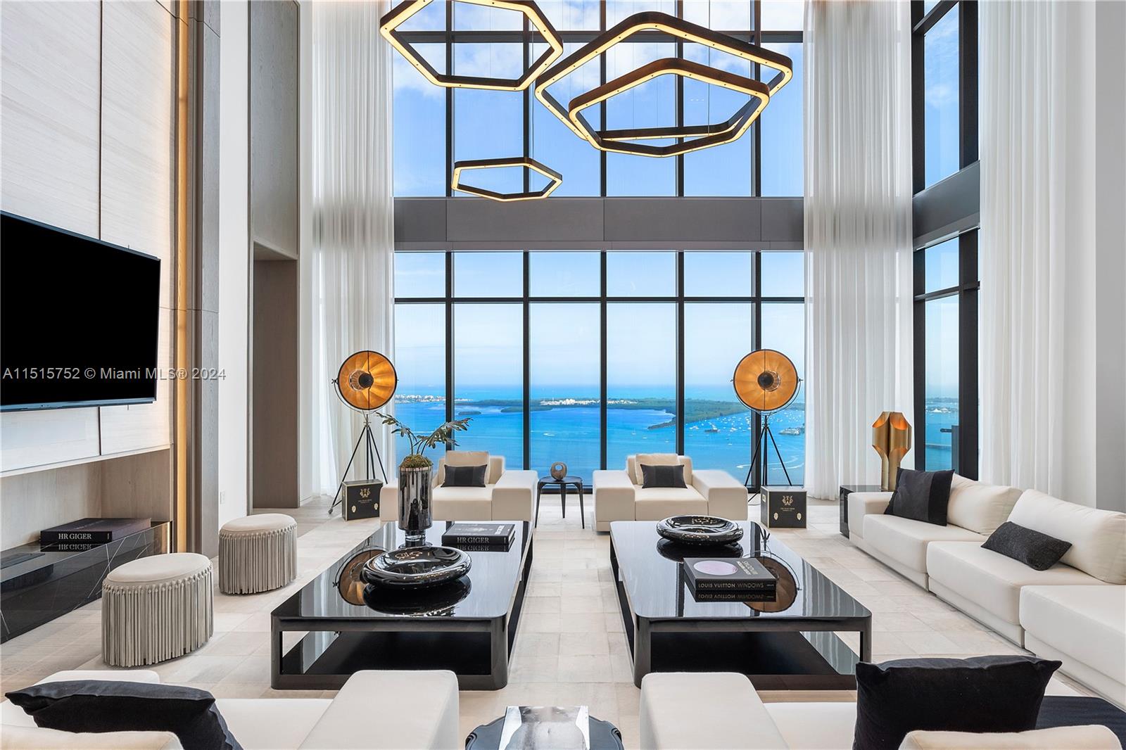 1451 Brickell Avenue, Unit PH56 Miami, FL 33131 - Photo 4 of 54 a living room with furniture a flat screen tv and a window