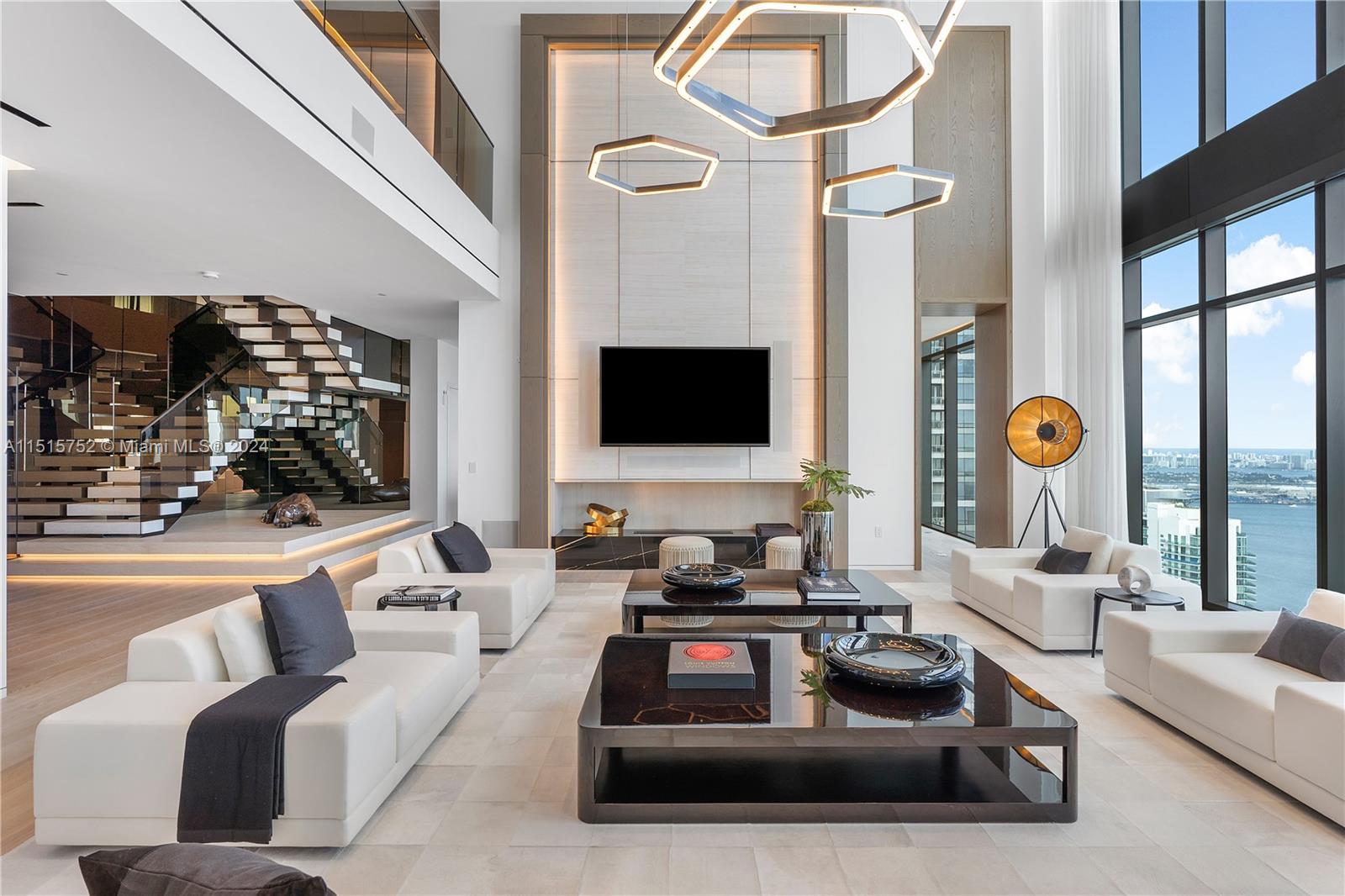 1451 Brickell Avenue, Unit PH56 Miami, FL 33131 - Photo 8 of 54 a living room with furniture and a flat screen tv