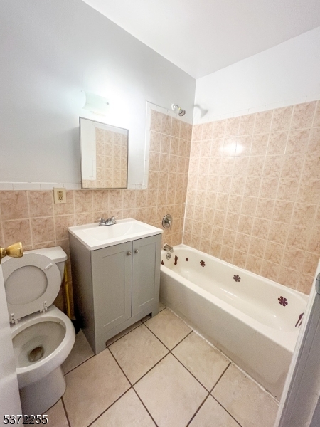 341 16th Avenue, Unit 2F Irvington, NJ 07111 - Photo 1 of 1 a bathroom with a granite countertop sink a toilet and shower