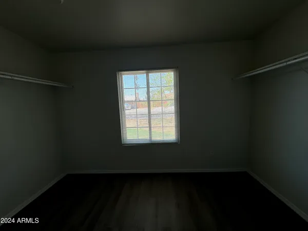 a view of a small space with wooden floor and a window