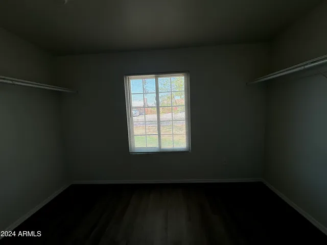 a view of a small space with wooden floor and a window