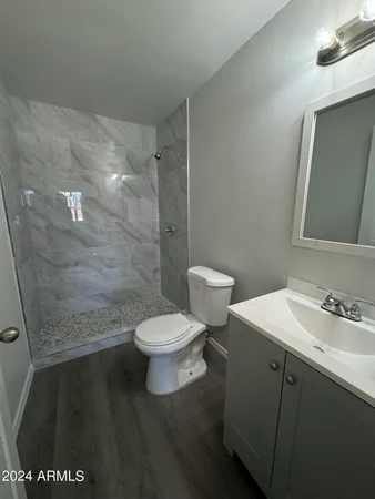 a white toilet sitting next to a bathroom sink