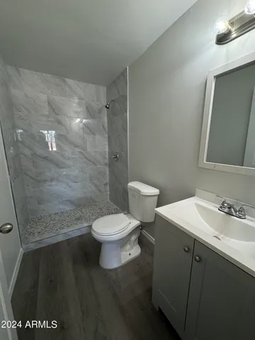 a white toilet sitting next to a bathroom sink