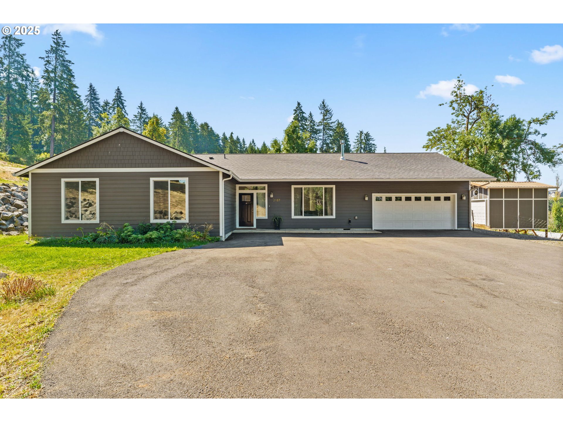2187 East Madison Avenue Cottage Grove, OR 97424 - Photo 1 of 41 a front view of a house with a garden