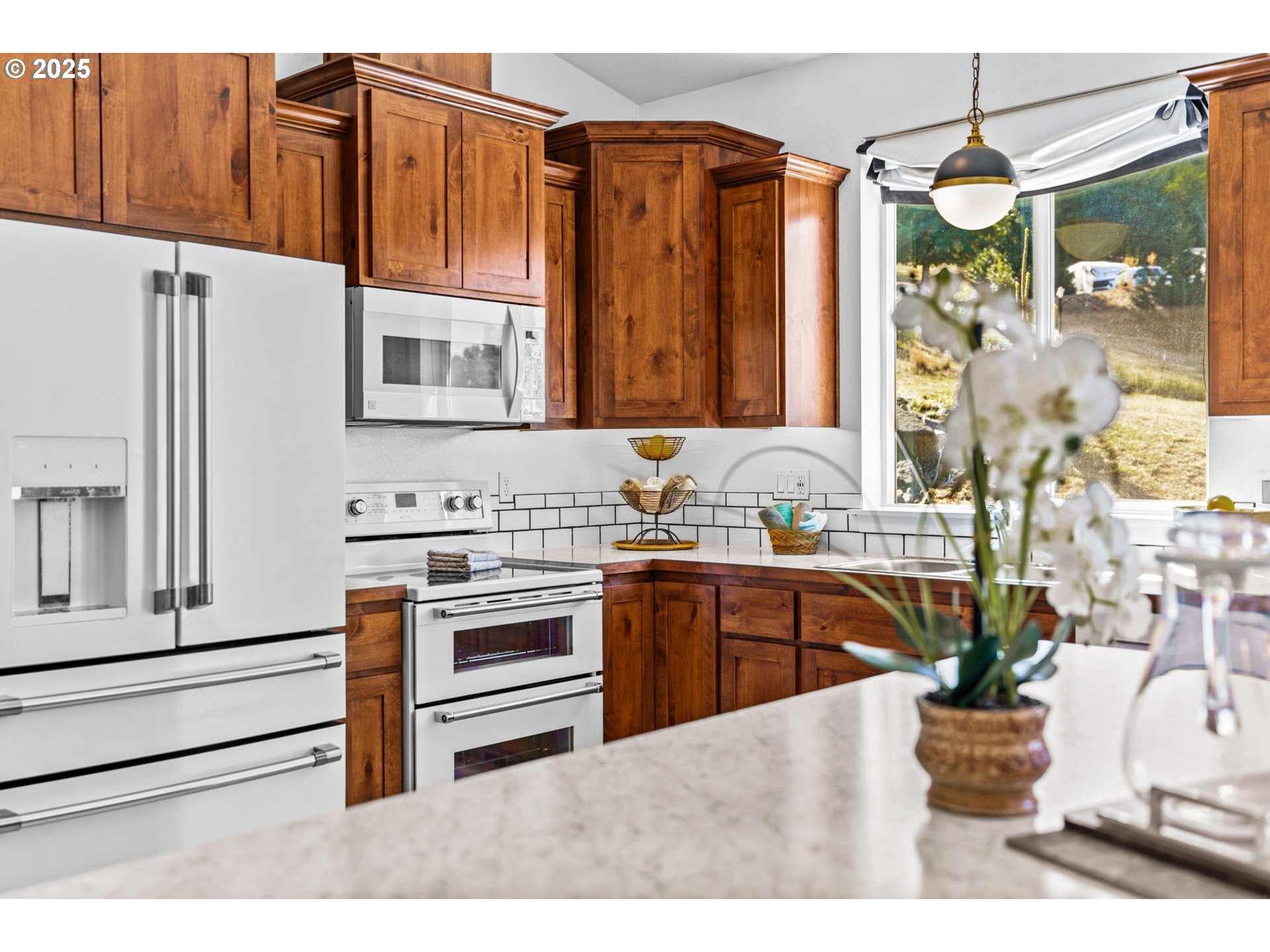 2187 East Madison Avenue Cottage Grove, OR 97424 - Photo 11 of 41 a kitchen with stainless steel appliances kitchen island granite countertop a refrigerator and a stove