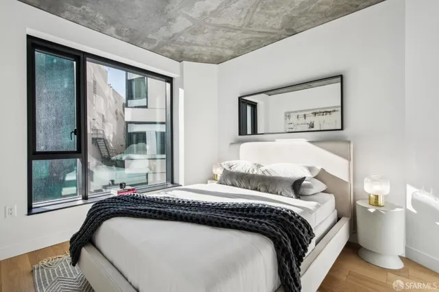 a bedroom with a bed and window