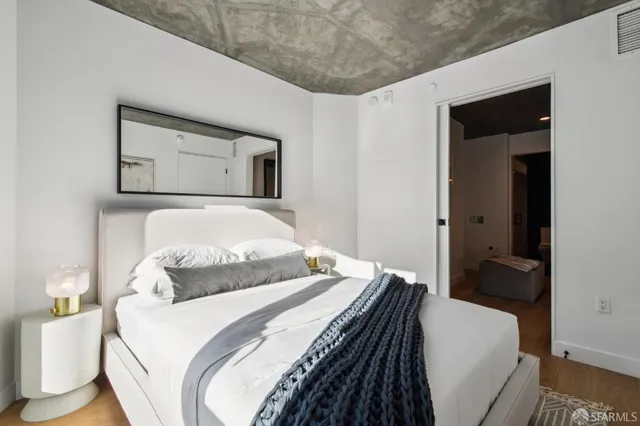 a bedroom with a bed and a mirror