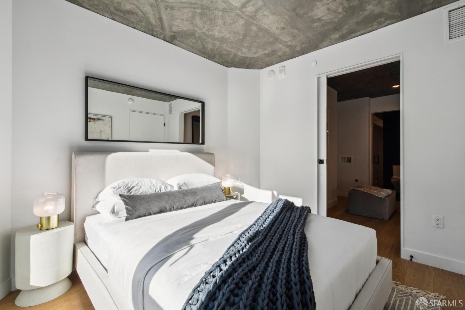 960 Market Street, Unit 423 San Francisco, CA 94102 - Photo 14 of 28 a bedroom with a bed and a mirror