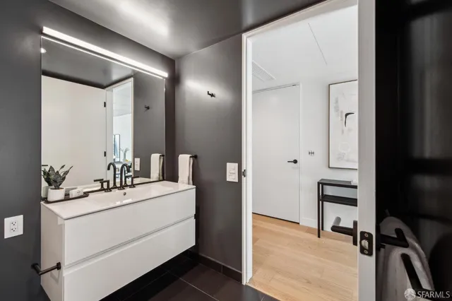 a bathroom with a double vanity sink toilet mirror and shower