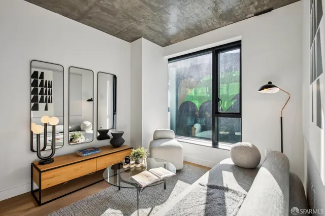 a living room with furniture and a floor to ceiling window