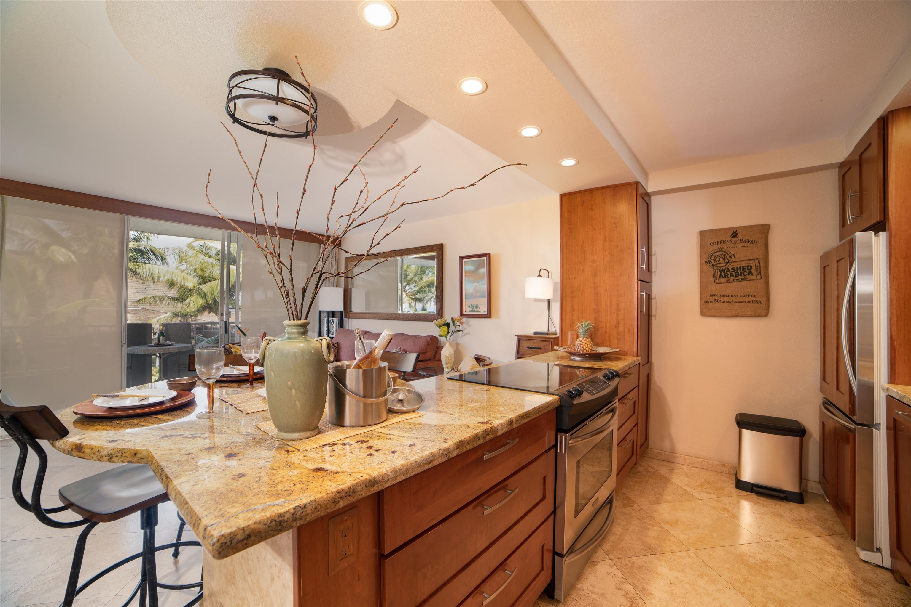 73 North Kihei Road, Unit 308 Kihei, HI 96753 - Photo 13 of 23 a dining room with stainless steel appliances granite countertop a sink and a refrigerator