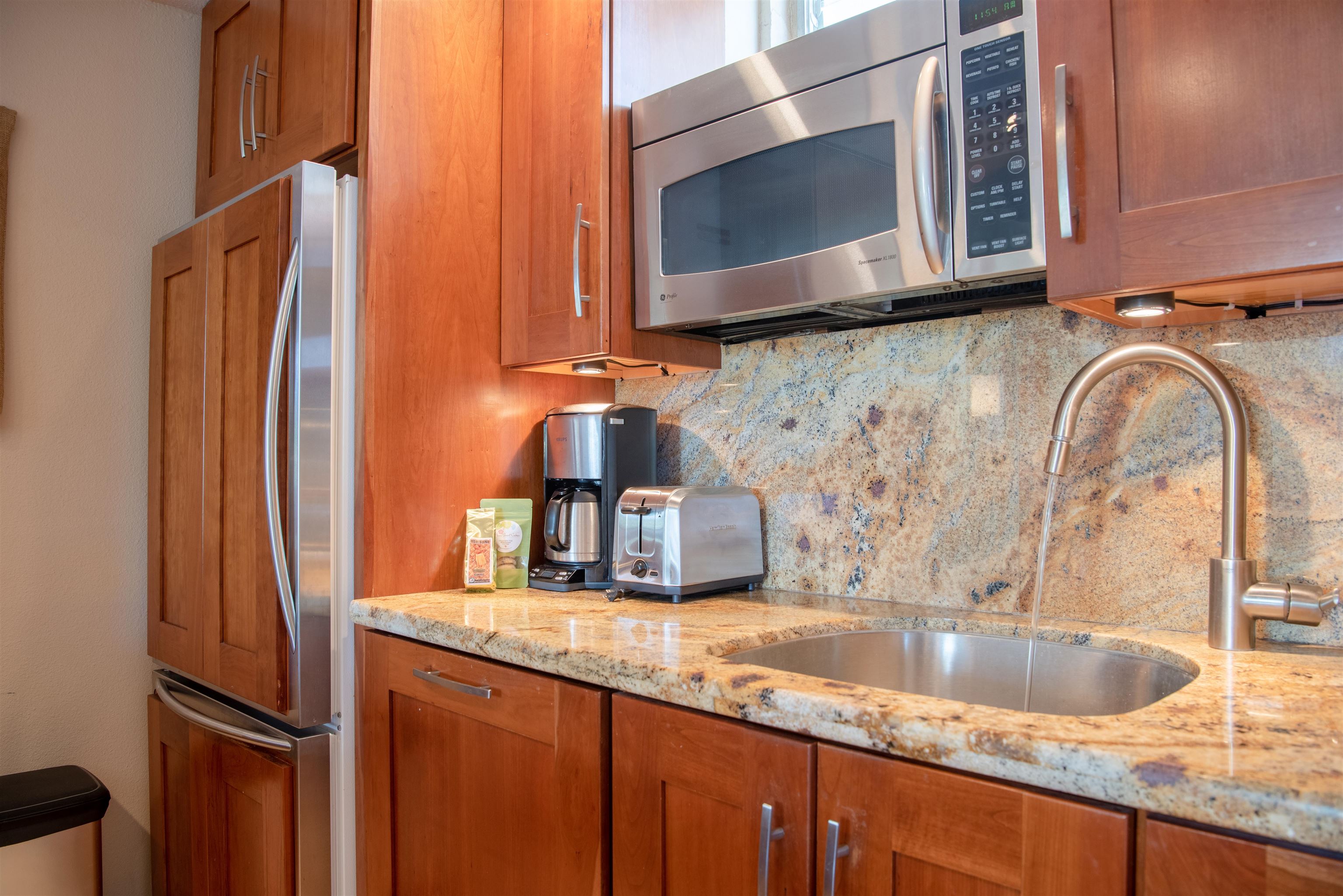 73 North Kihei Road, Unit 308 Kihei, HI 96753 - Photo 14 of 23 a kitchen with stainless steel appliances granite countertop a sink and a microwave