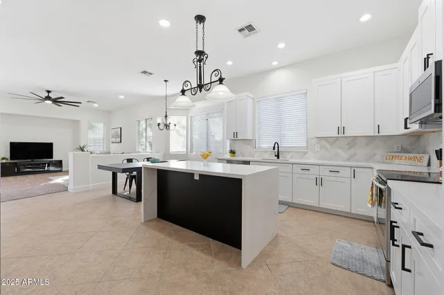 a kitchen with stainless steel appliances cabinets and a window