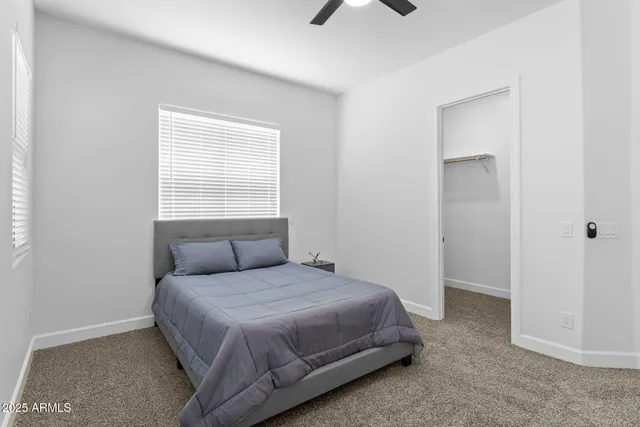 a kitchen with white cabinets and sink