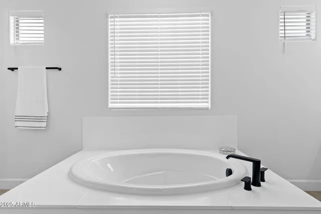 a bathroom with double vanity sink and mirror