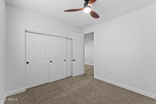 a aerial view of a house with a yard and large tree