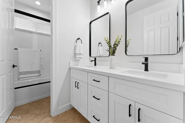 a view of a white house with a big yard and large trees