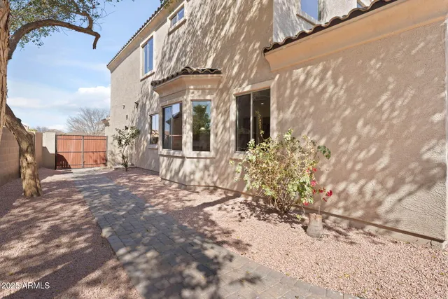 an aerial view of a house with a yard and lake view