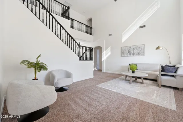 a living room with furniture and a view of kitchen