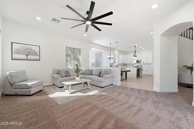 a kitchen with kitchen island a sink a center island stainless steel appliances and a window