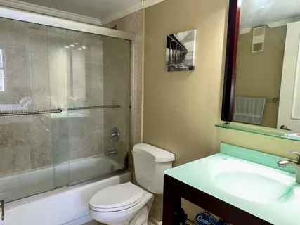 a bathroom with a sink toilet and shower