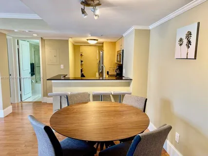 a room with a table chairs and wooden floor