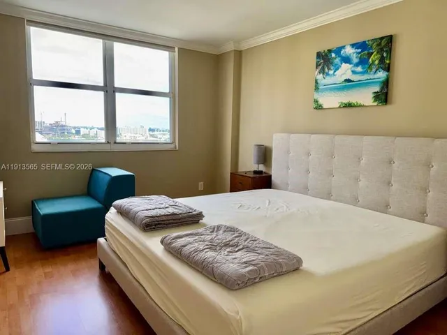 a bedroom with a bed and a couch