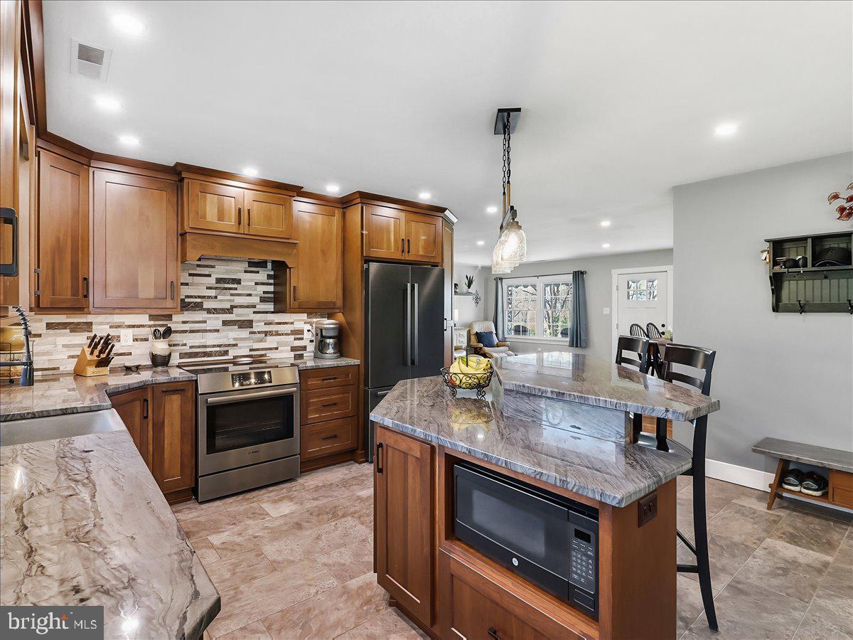 41 Porters Mill Road Pottstown, PA 19465 - Photo 2 of 37 Walnut stained cabinetry with Quartzite counters