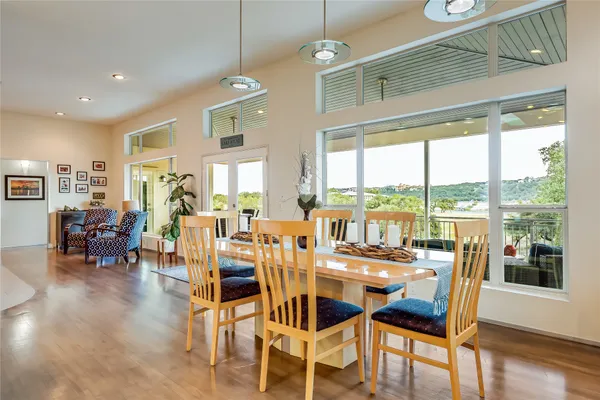 a dining room with furniture window and wooden floor