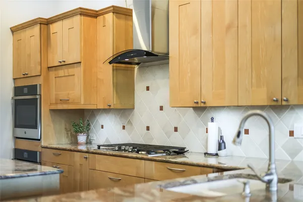 a bathroom with a tub a sink double vanity and a mirror