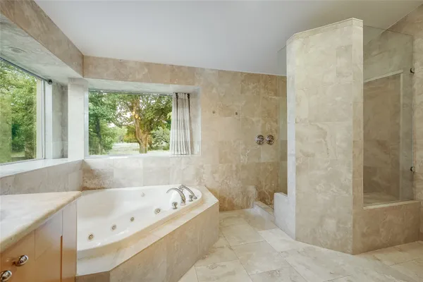 a bathroom with a double vanity sink mirror and shower