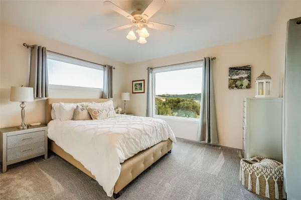 a bedroom with a bed and a painting on the wall