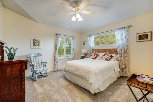 a living room with furniture a rug and a chandelier