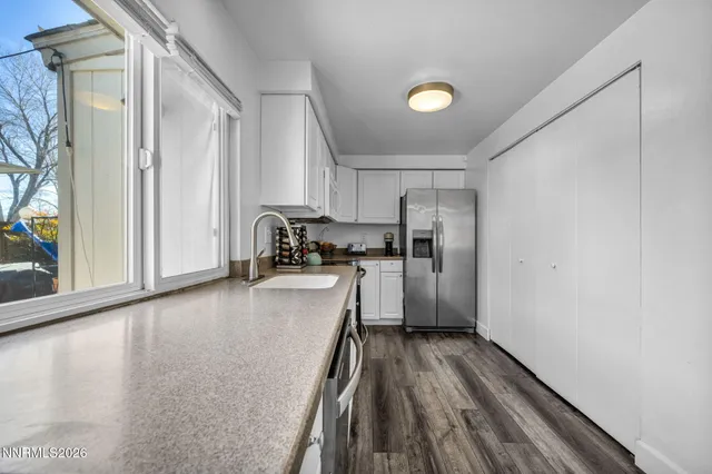 a kitchen with a refrigerator and a stove top oven