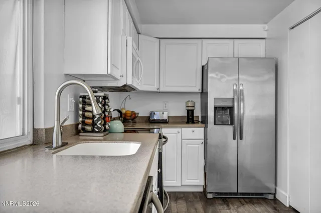 a kitchen with stainless steel appliances a refrigerator sink and cabinets