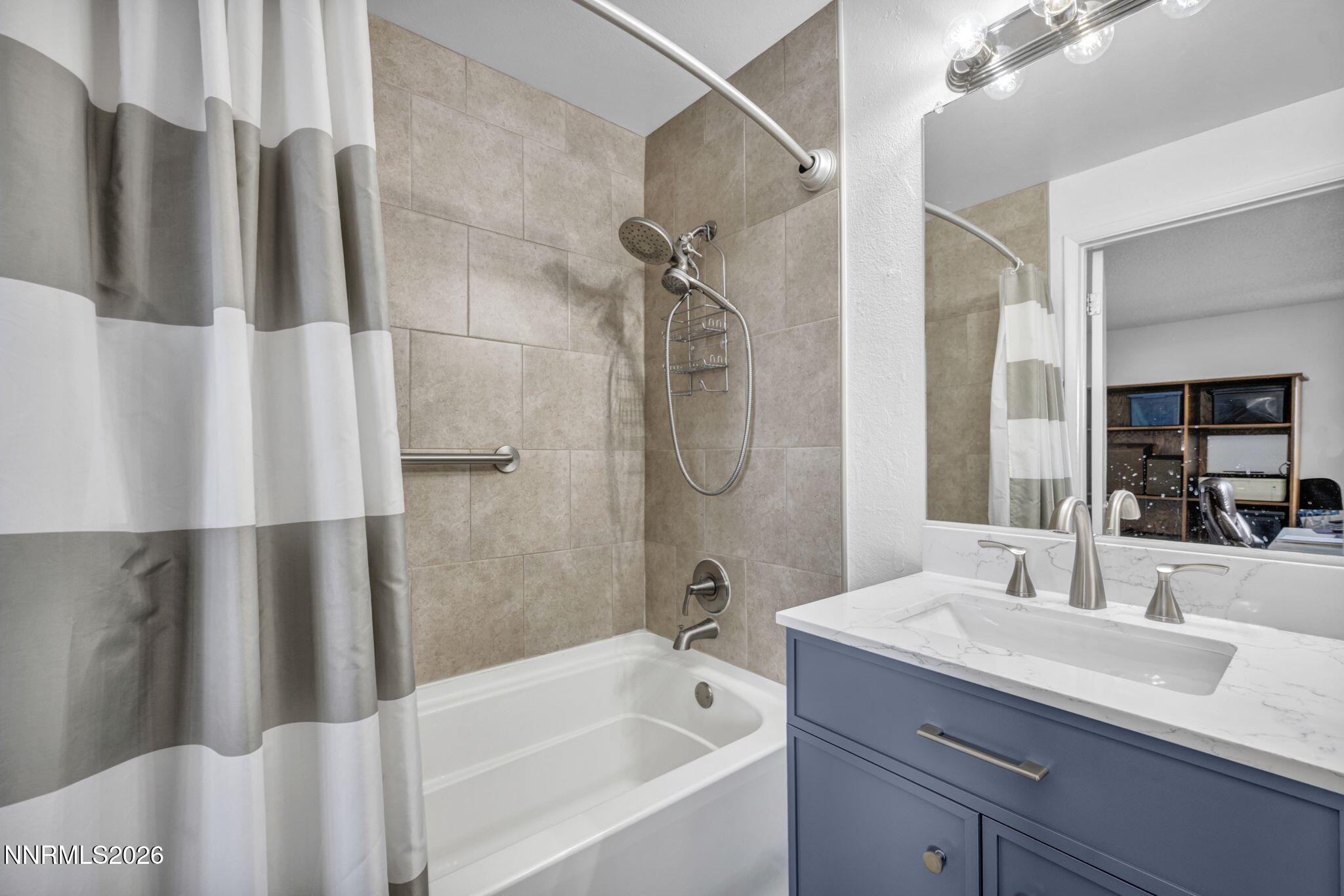959 Mesa Ridge Drive, Unit 2 Sparks, NV 89434 - Photo 17 of 41 a bathroom with a granite countertop sink a mirror a shower and a bathtub